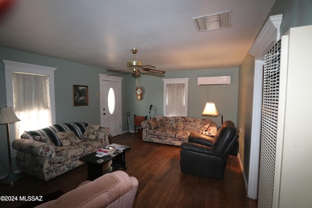 living room with dark wood-type flooring, ceiling fan, and an AC wall unit