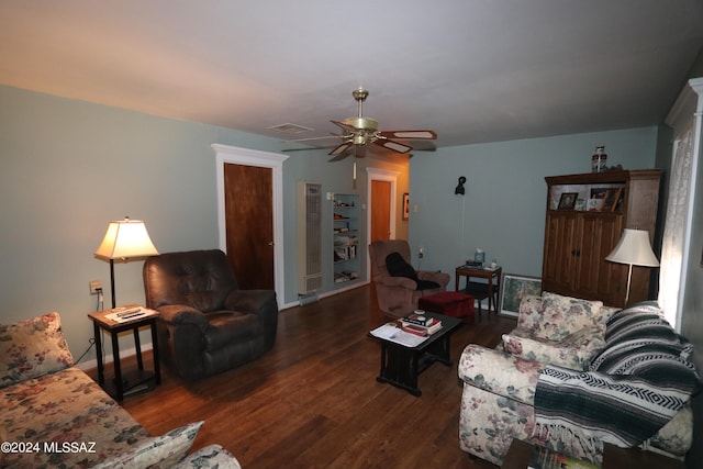 living room with dark hardwood / wood-style flooring and ceiling fan