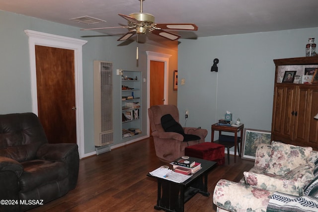 living room featuring ceiling fan and dark hardwood / wood-style floors