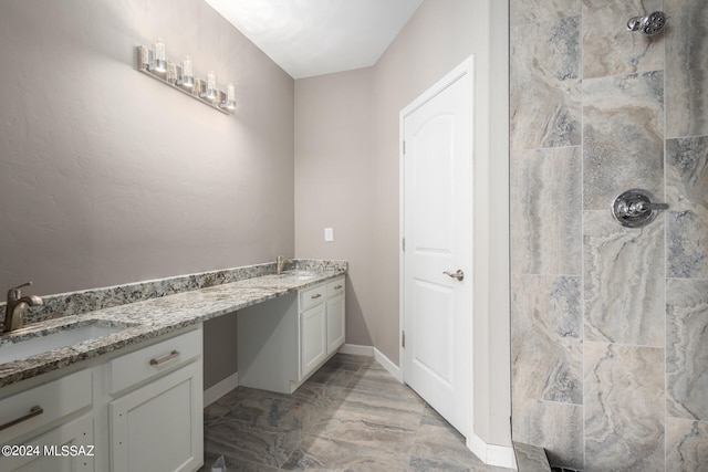 bathroom with vanity and tiled shower