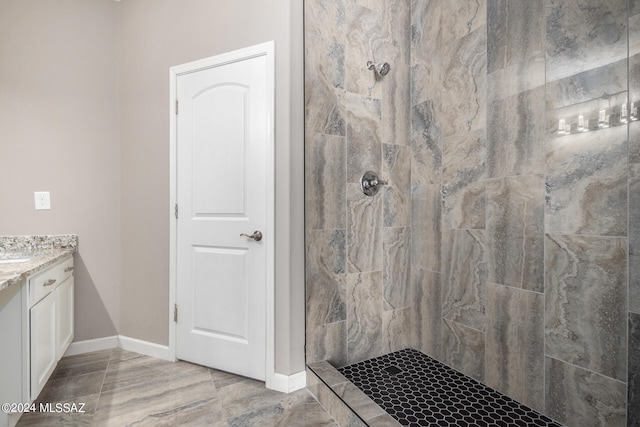 bathroom featuring vanity and a tile shower