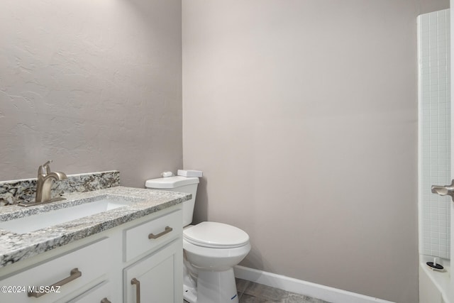 bathroom with vanity, toilet, and a shower