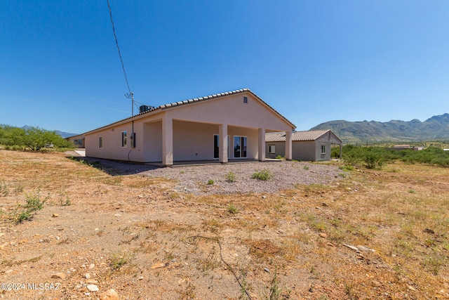 rear view of house featuring a mountain view