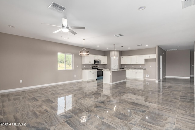 unfurnished living room with ceiling fan and sink