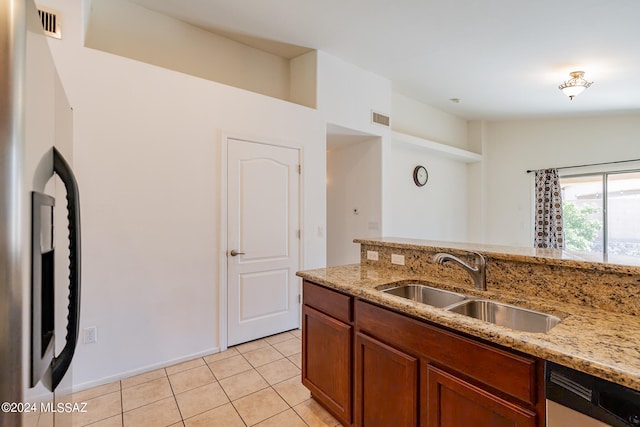 kitchen featuring light stone counters, stainless steel appliances, sink, and light tile patterned flooring