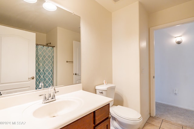 bathroom featuring tile patterned flooring, vanity, and toilet