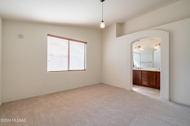 empty room with lofted ceiling and light carpet