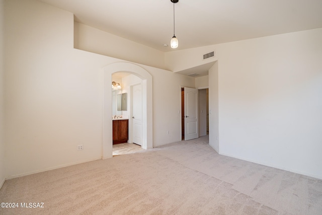 carpeted spare room featuring lofted ceiling