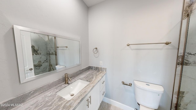 bathroom featuring walk in shower, hardwood / wood-style floors, vanity, and toilet