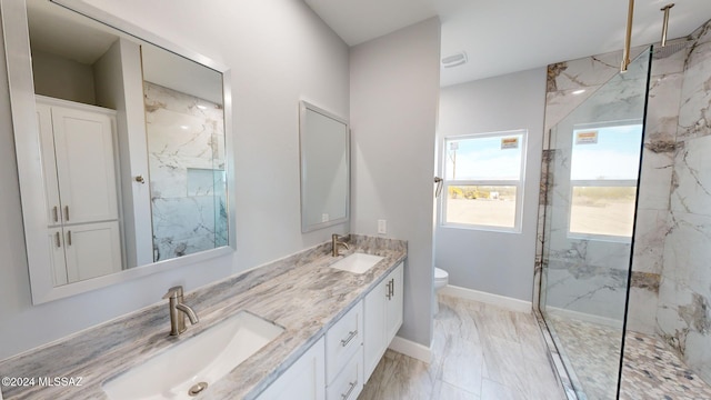 bathroom featuring toilet, vanity, and tiled shower