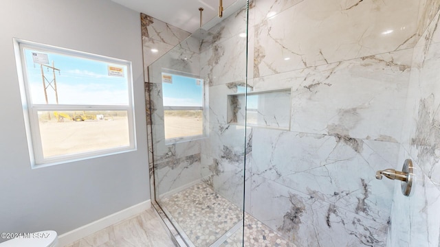 bathroom featuring toilet and a tile shower