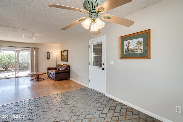 interior space featuring a textured ceiling and ceiling fan