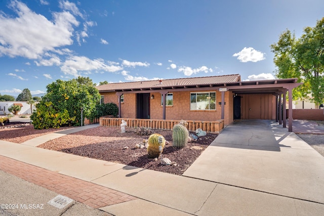 view of front of property with covered porch and a carport