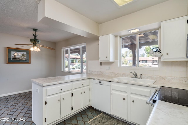 kitchen featuring dishwasher, kitchen peninsula, sink, tasteful backsplash, and white cabinetry