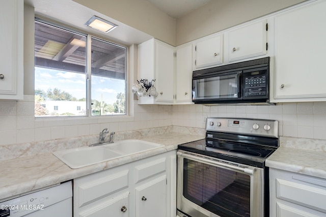 kitchen with dishwasher, backsplash, white cabinets, electric stove, and sink