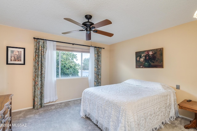 bedroom with light carpet, a textured ceiling, and ceiling fan