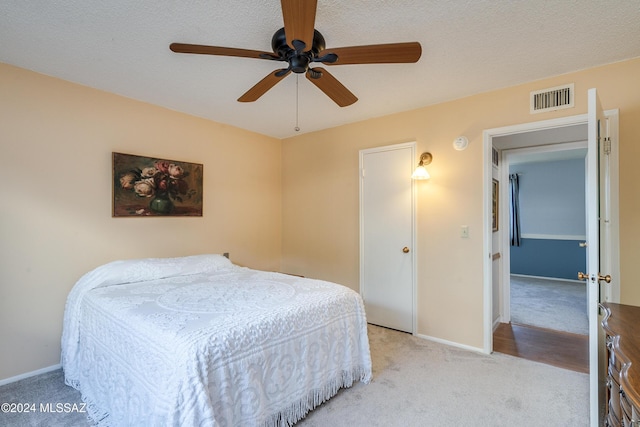 bedroom featuring light colored carpet and ceiling fan