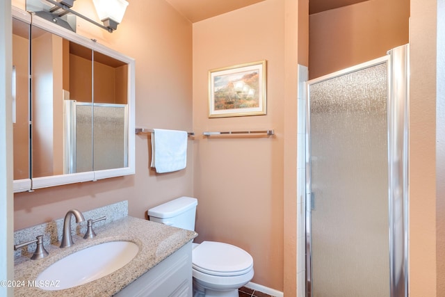 bathroom with vanity, an enclosed shower, and toilet