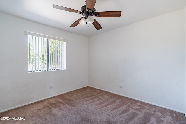 carpeted empty room featuring ceiling fan