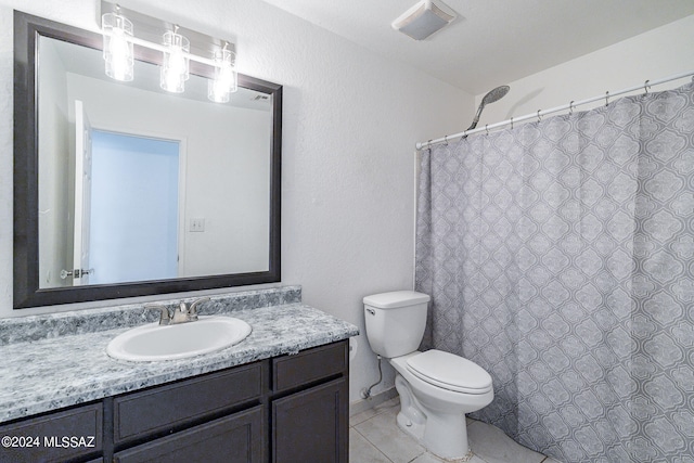 bathroom with tile patterned flooring, curtained shower, vanity, and toilet