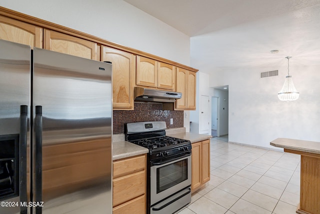 kitchen featuring light brown cabinets, light tile patterned floors, decorative light fixtures, appliances with stainless steel finishes, and decorative backsplash