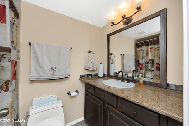 bathroom with toilet and vanity