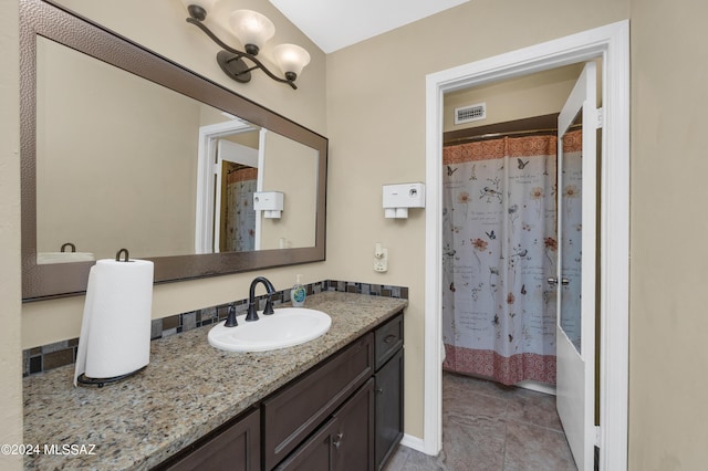 bathroom with vanity, shower / bath combination with curtain, and tile patterned flooring