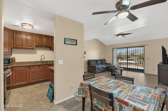 dining area with ceiling fan and sink