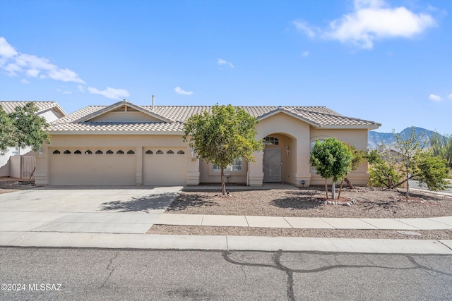 view of front of home with a mountain view and a garage