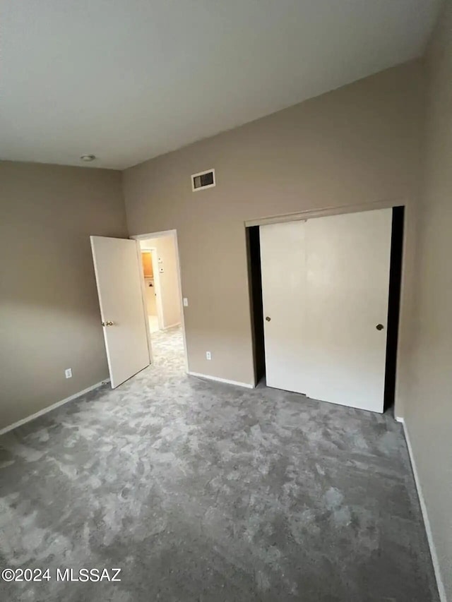 unfurnished bedroom featuring a closet and carpet floors