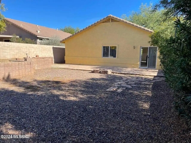 back of house with a patio