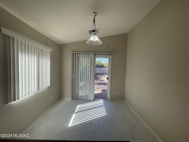 unfurnished room featuring lofted ceiling