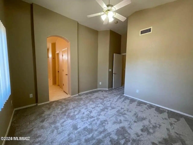 unfurnished bedroom with light carpet, lofted ceiling, and ceiling fan