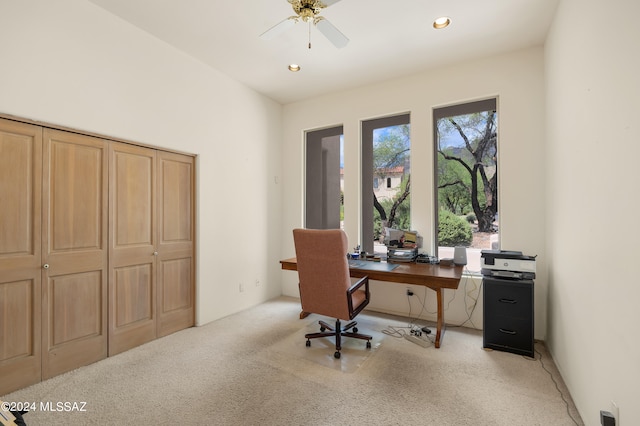 office space featuring ceiling fan and light carpet