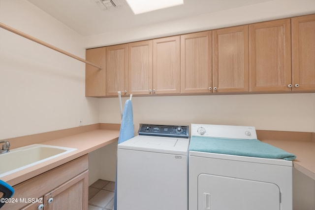 washroom featuring cabinets, light tile patterned floors, separate washer and dryer, and sink