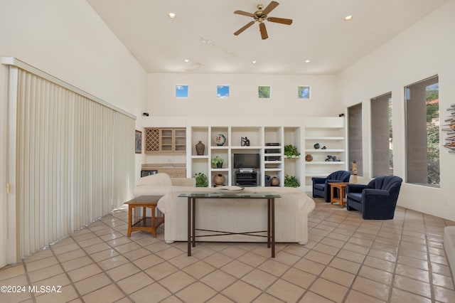 tiled living room featuring a towering ceiling and ceiling fan