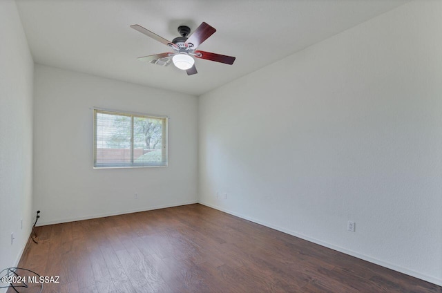 empty room featuring baseboards, ceiling fan, and wood finished floors