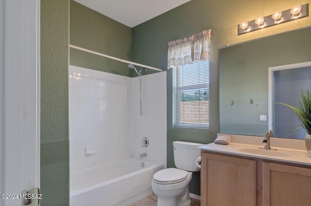 full bathroom featuring toilet,  shower combination, vanity, and a textured wall