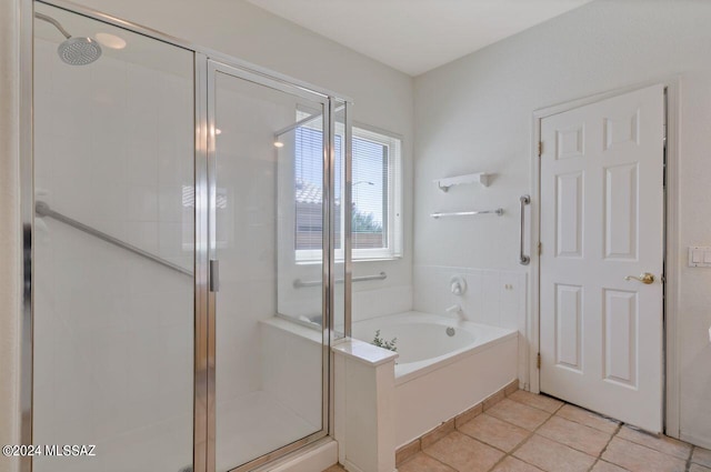 bathroom with a garden tub, a stall shower, and tile patterned flooring