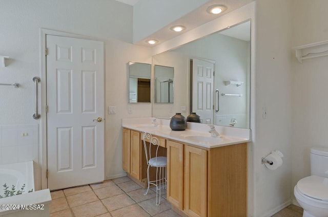 full bathroom featuring toilet, a sink, tile patterned flooring, double vanity, and walk in shower