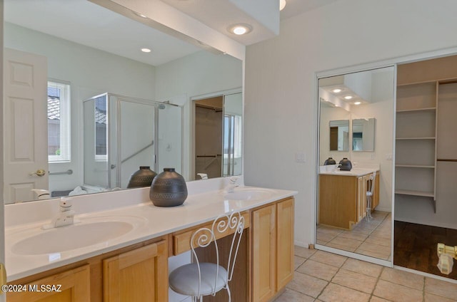 bathroom with vanity, a shower with shower door, and tile patterned flooring