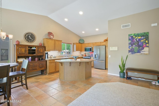 kitchen featuring tasteful backsplash, sink, a center island, stainless steel appliances, and an inviting chandelier