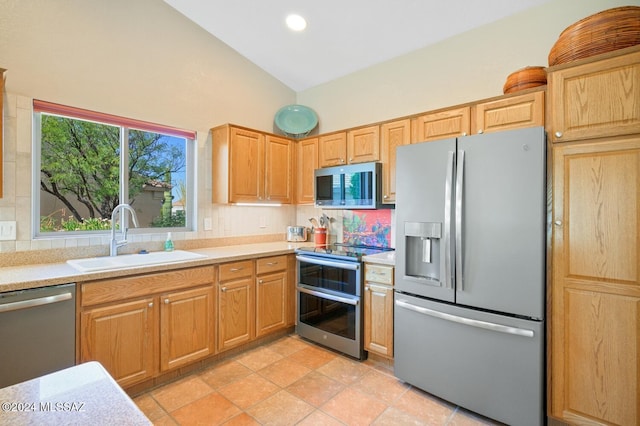 1892 E E Clf, Swallow Trail, Green Valley, AZ 85614 - kitchen featuring appliances with stainless steel finishes, a sink, light countertops, high vaulted ceiling, and backsplash