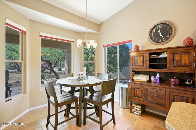 tiled dining area with vaulted ceiling and a notable chandelier