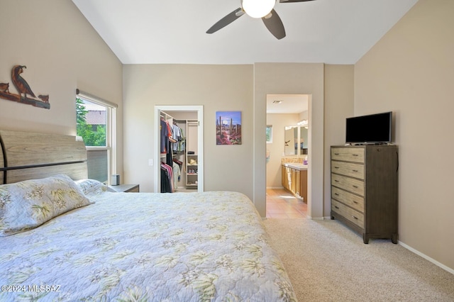 carpeted bedroom featuring connected bathroom, ceiling fan, a closet, and a walk in closet