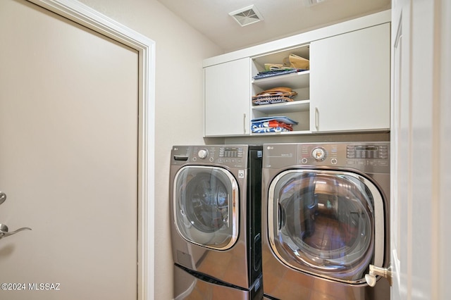 1892 E E Clf, Swallow Trail, Green Valley, AZ 85614 - laundry room featuring cabinet space, visible vents, and washer and clothes dryer