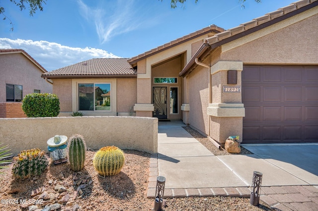 1892 E E Clf, Swallow Trail, Green Valley, AZ 85614 - entrance to property featuring an attached garage, stucco siding, and a tile roof