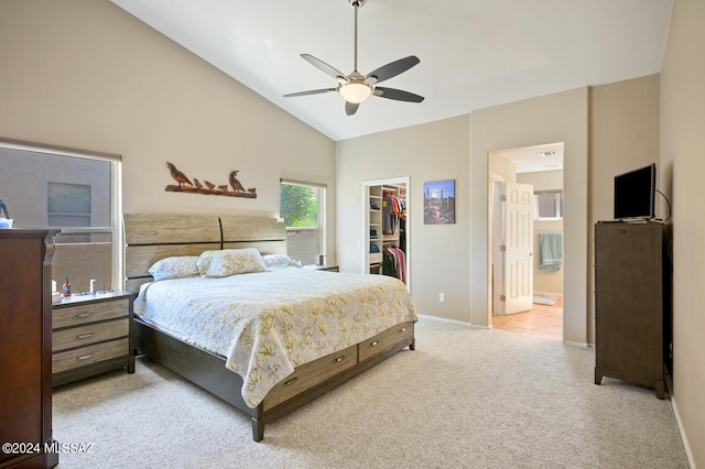 carpeted bedroom featuring a spacious closet, a closet, ceiling fan, connected bathroom, and high vaulted ceiling