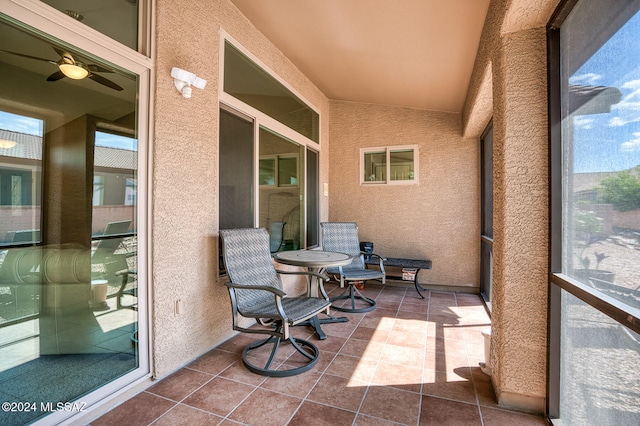 sunroom featuring ceiling fan and vaulted ceiling