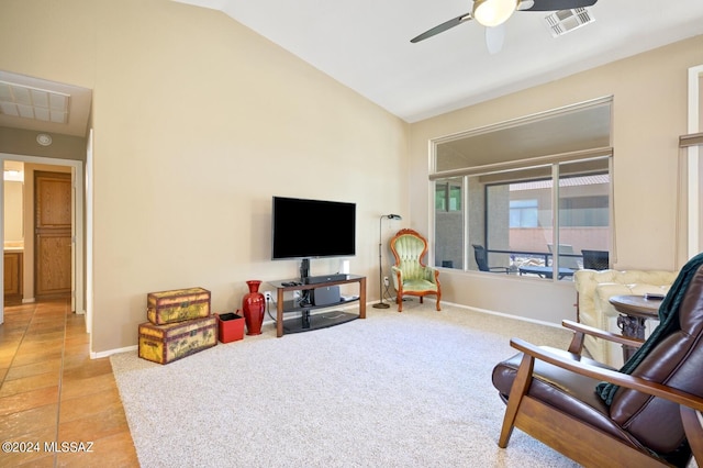 sitting room featuring lofted ceiling, light tile patterned floors, and ceiling fan